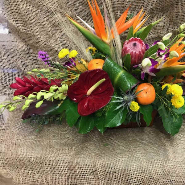 Tropical floral arrangement with orange bird-of-paradise and red anthurium