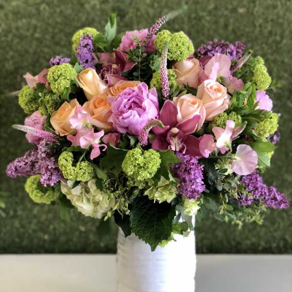 Bouquet of pink and peach flowers in a white vase