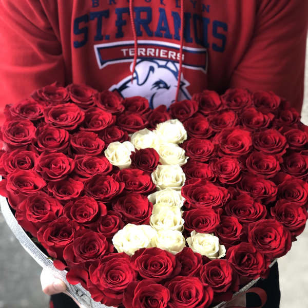 Heart-shaped bouquet of red and white roses in a gift box