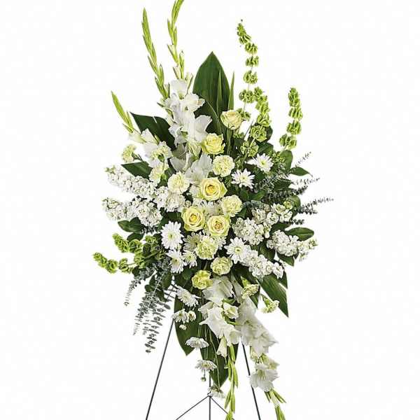 Tall white and green standing funeral spray on a metal easel