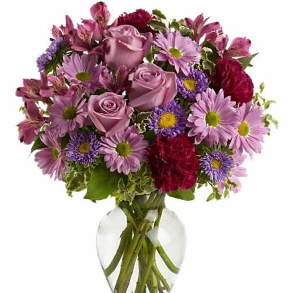 Pink and purple mixed bouquet in a clear glass vase
