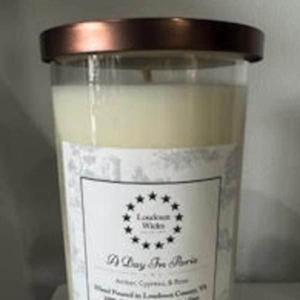 Large cream-colored candle in a glass jar with a metal lid