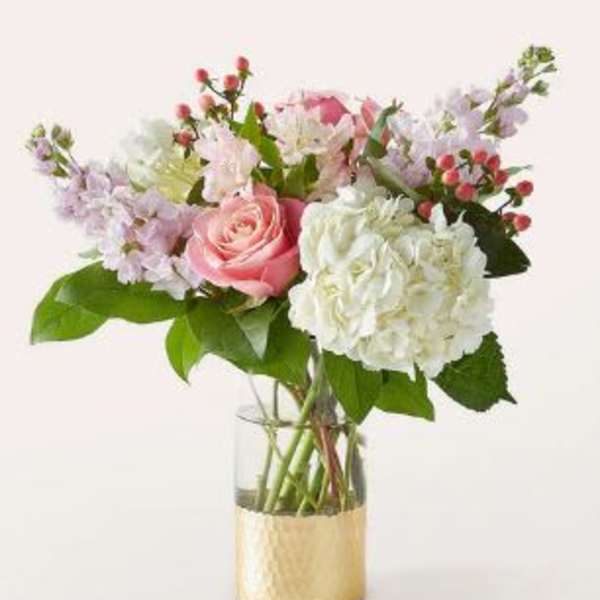 Pink and white bouquet in a gold vase