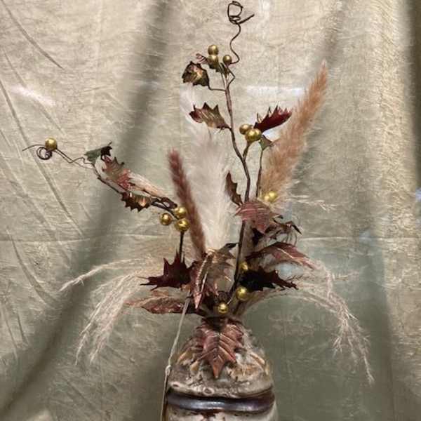 Tall dried floral arrangement in a ceramic vase with feathery plumes and gold accents