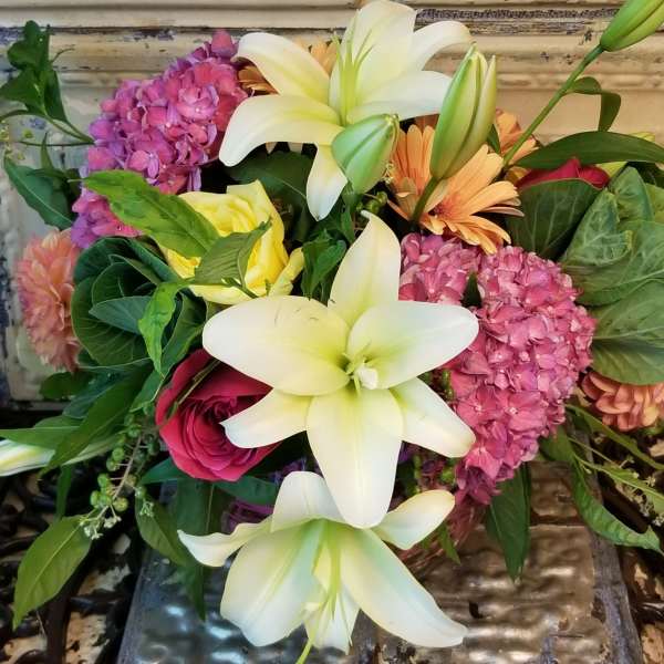 Bouquet of white lilies, pink hydrangeas, and mixed roses