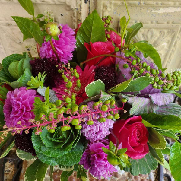Bouquet of pink and purple flowers with green foliage