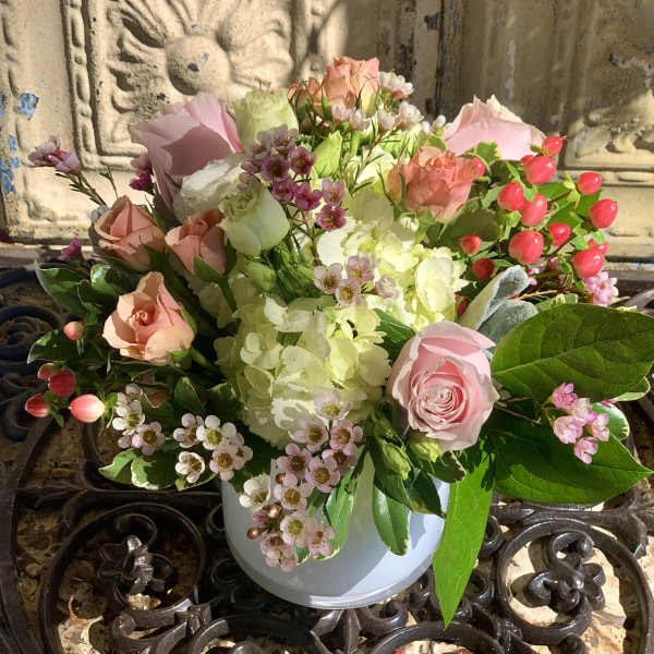 Pink and white rose bouquet in a white vase