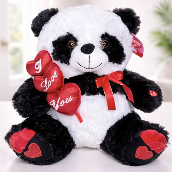 Plush panda bear holding red heart decorations and a ribbon