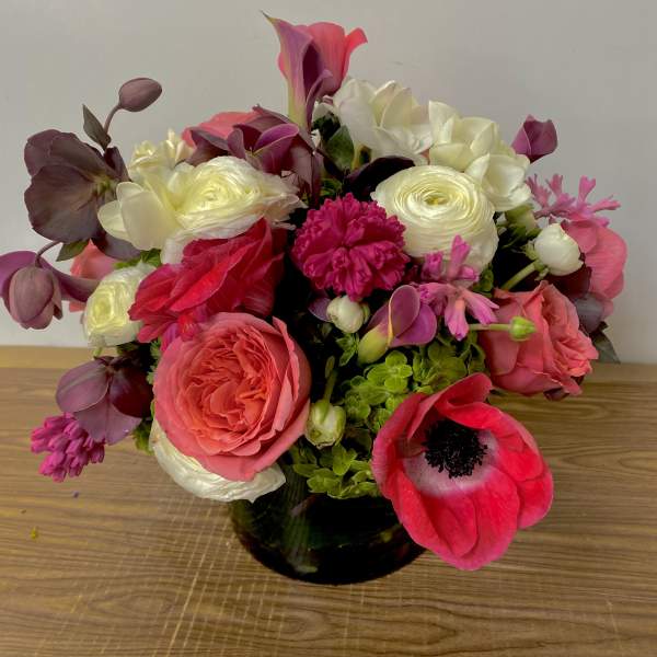 Mixed pink and white bouquet in a dark glass vase