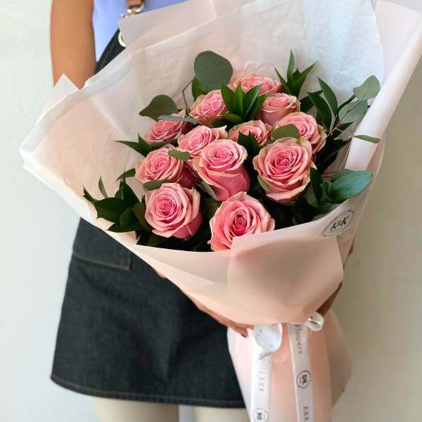 Bouquet of pink roses wrapped in pale pink paper
