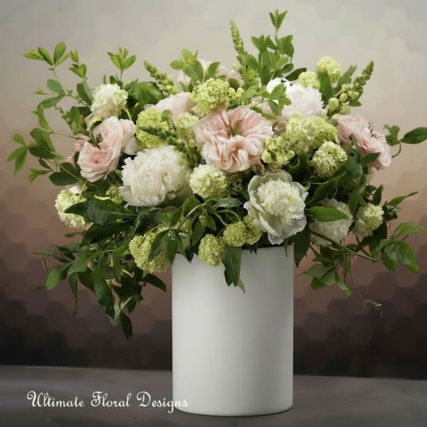 Blush and white floral arrangement in a white vase