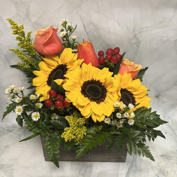 Sunflowers and peach roses in a rectangular wooden box