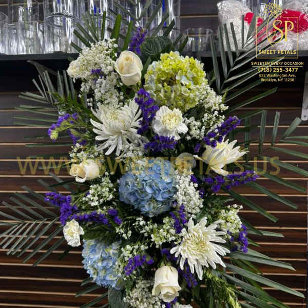 Standing floral spray with white, blue, and purple flowers