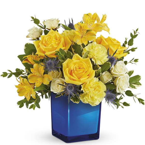 Yellow and white roses with yellow alstroemeria in a blue vase