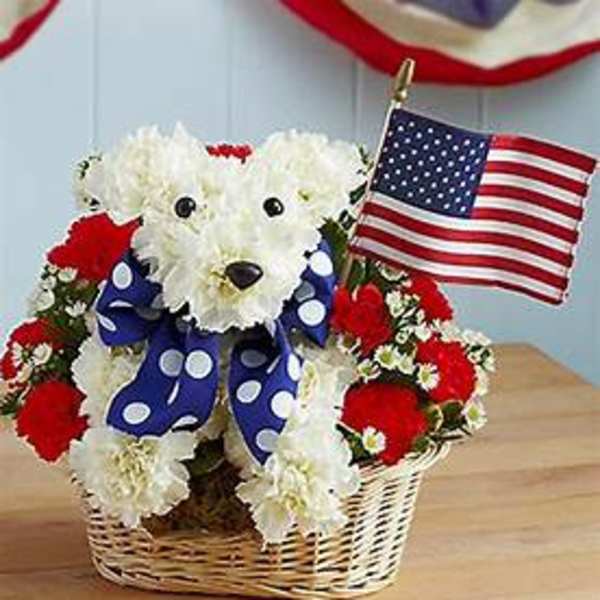 White teddy bear made of flowers in a basket with a small American flag