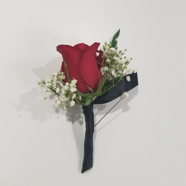 Red rose boutonniere with white baby's breath and black ribbon