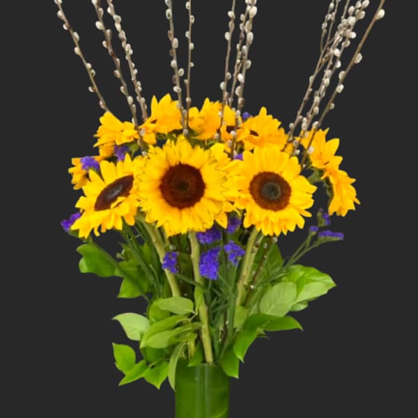 Sunflowers in a green vase with pussy willow branches