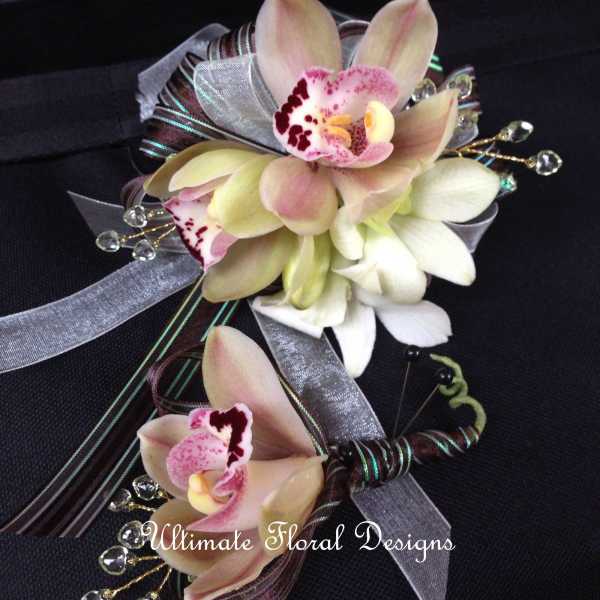 Two orchid corsages with silver and burgundy ribbon accents