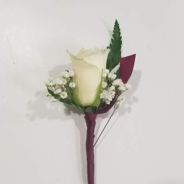 White rose boutonniere with baby's breath and burgundy ribbon