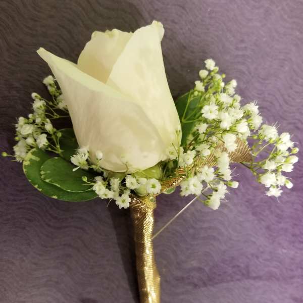 White rose boutonniere with baby's breath and gold wrap