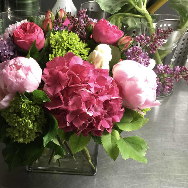 Pink and white floral arrangement in a glass vase