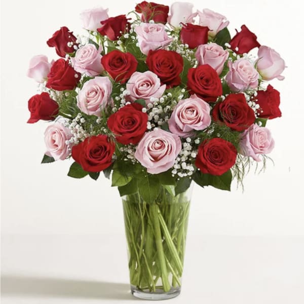 Bouquet of red and pink roses in a clear glass vase