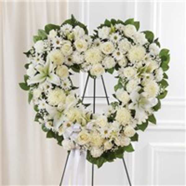 Heart-shaped white floral wreath on a standing easel