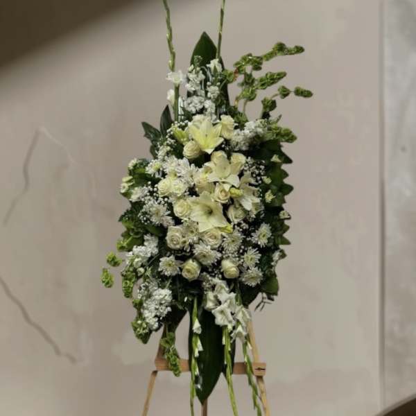 Tall white floral standing arrangement on an easel