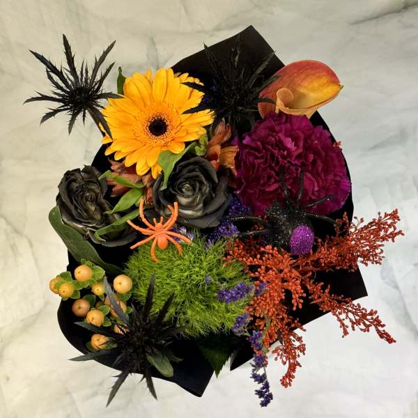 Halloween bouquet with orange gerbera, black roses, and a calla lily