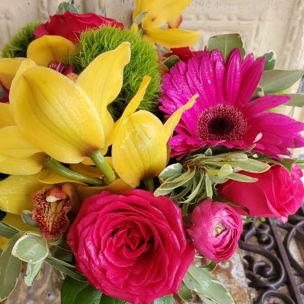 Bouquet of yellow calla lilies, pink gerbera daisies, and roses