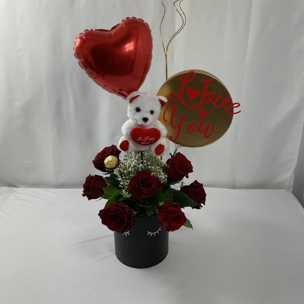 Red roses in a black box with a teddy bear and heart balloon