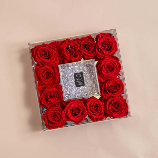 Square box of red roses with a clear jeweled center