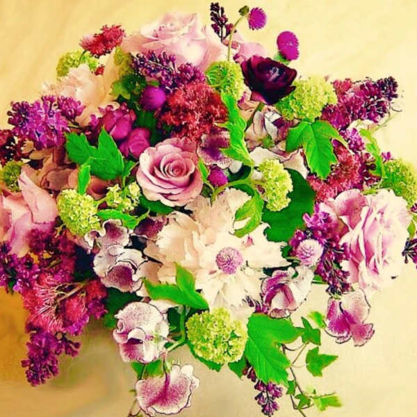 Bouquet of pink, purple, and white flowers with bright green accents