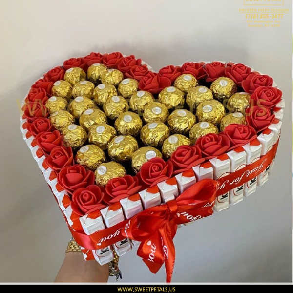 Heart-shaped gift box with red roses and gold-wrapped chocolates