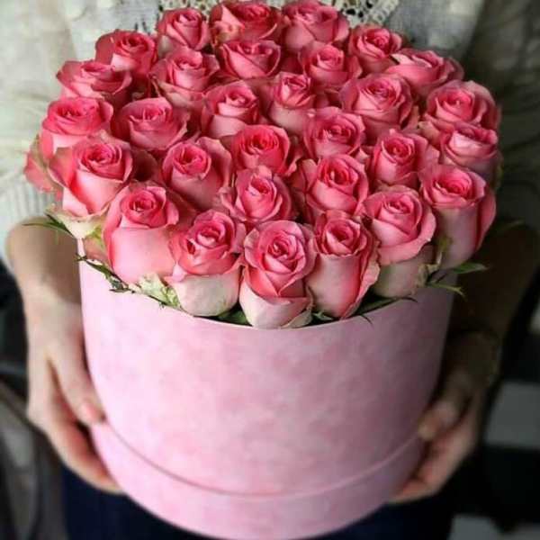Pink roses arranged in a round pink box