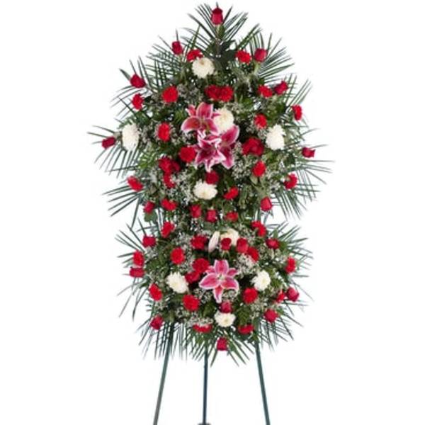 Standing funeral spray with red and white flowers on a tripod easel