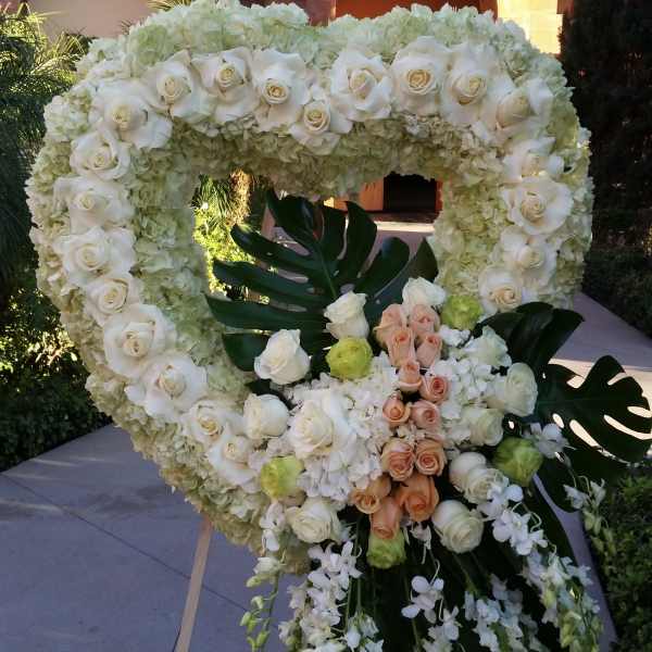 Heart-shaped floral wreath with white roses and hydrangeas