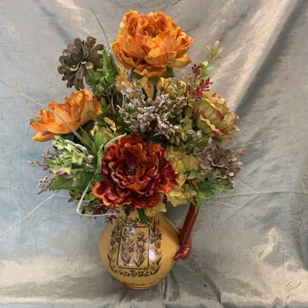Orange floral arrangement in a decorative ceramic vase