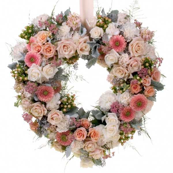 Heart-shaped floral wreath with pink and white roses and daisies