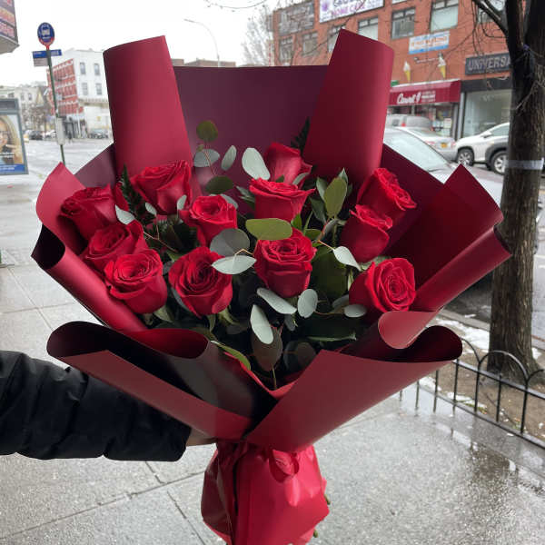 Bouquet of red roses wrapped in burgundy paper