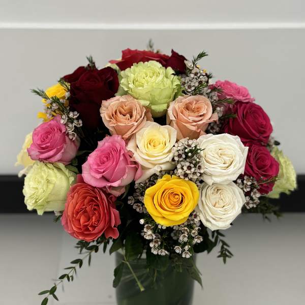 Mixed rose bouquet in a dark glass vase