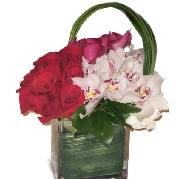 Red roses and white orchids in a square glass vase with a green handle