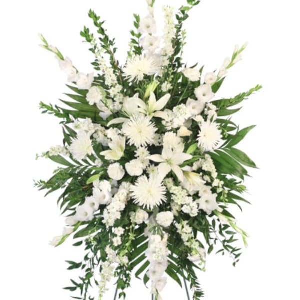 White funeral spray with lilies and chrysanthemums on a white background