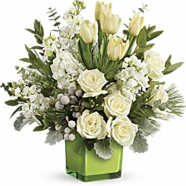 White roses and tulips in a green glass vase