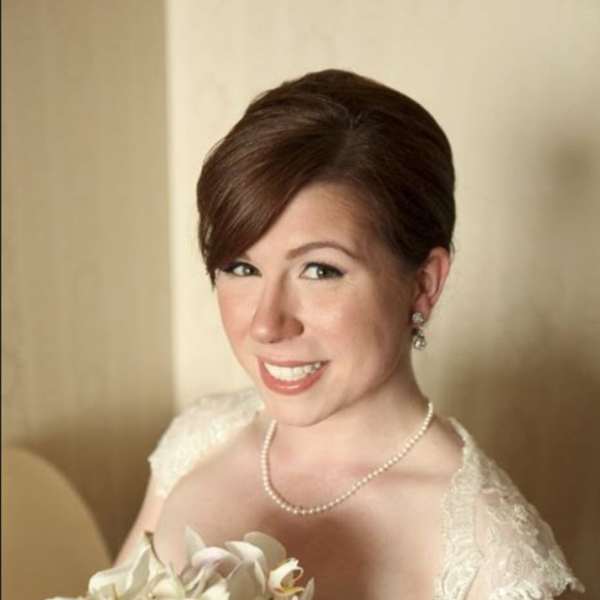 Bride holding a white orchid bouquet