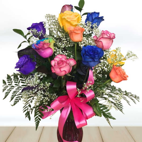 Colorful rose bouquet in a vase with a pink ribbon