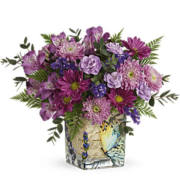Purple mixed bouquet in a butterfly-printed square vase