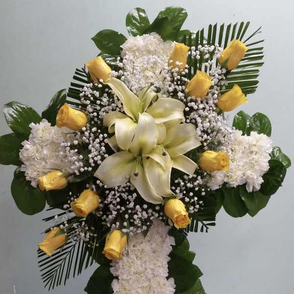 White floral standing spray with yellow roses and lilies