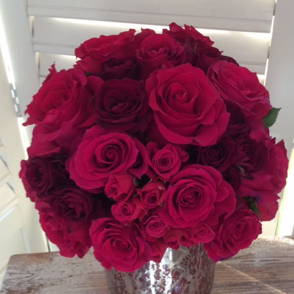 Bouquet of deep pink roses in a silver vase