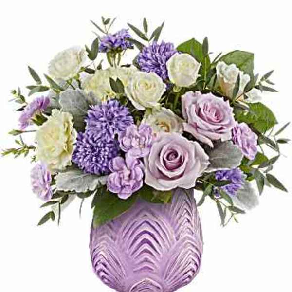 Lavender and white bouquet in a purple vase